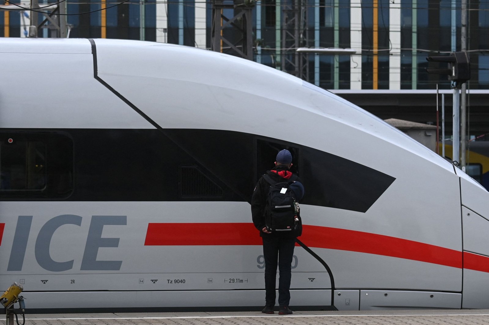 An employee of German railway operator Deutsche Bahn (DB) stands next to an ICE high-speed train during a strike called by the German train drivers union (GDL) at the main railway station in Munich, southern Germany, on Aug. 23, 2021. (AFP Photo)