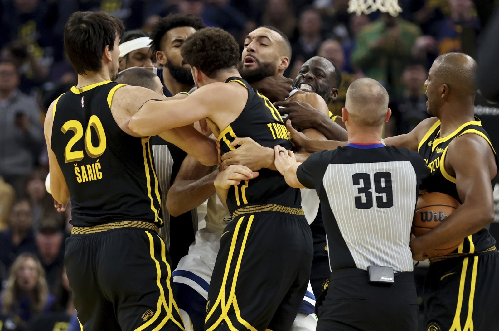 Golden State Warriors&#039; Klay Thompson (front) and Draymond Green (back) get into an altercation with Minnesota Timberwolves center Rudy Gobert (middle) during the first half of an in-season NBA tournament basketball game, San Francisco, U.S., Nov. 14, 2023. (AP Photo)