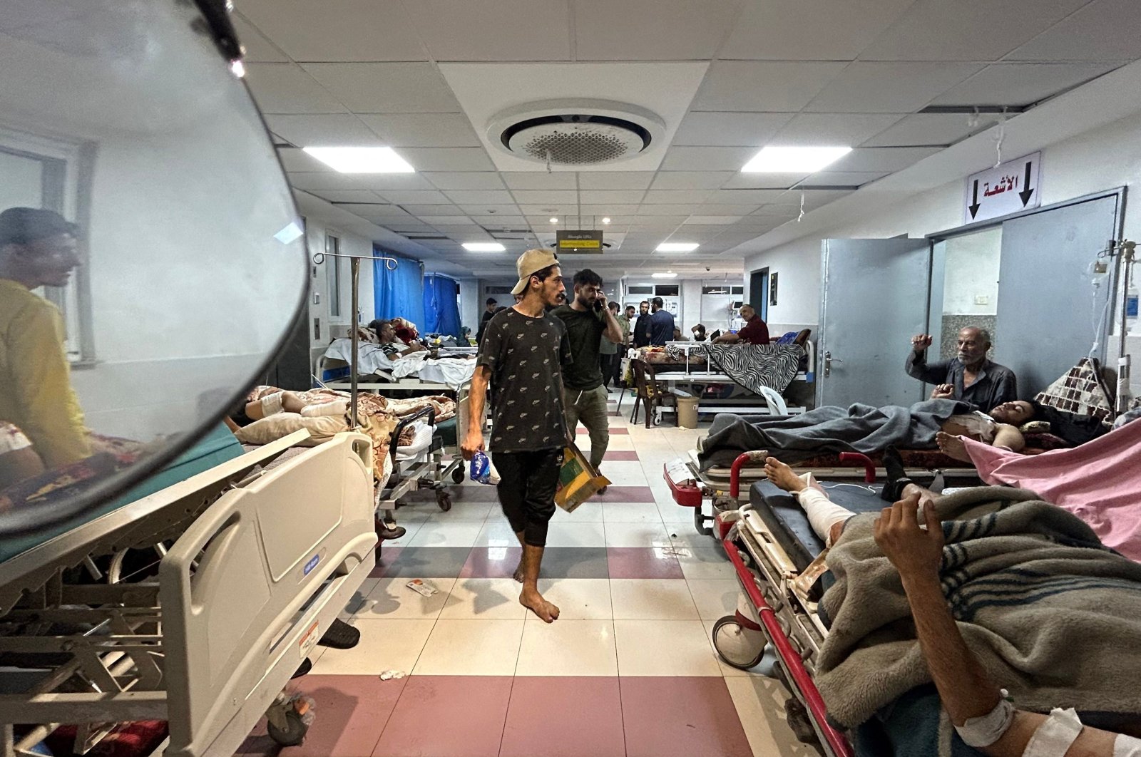 Men walk as patients rest at Al-Shifa hospital in Gaza City, Palestine, Nov. 10, 2023. (AFP Photo)