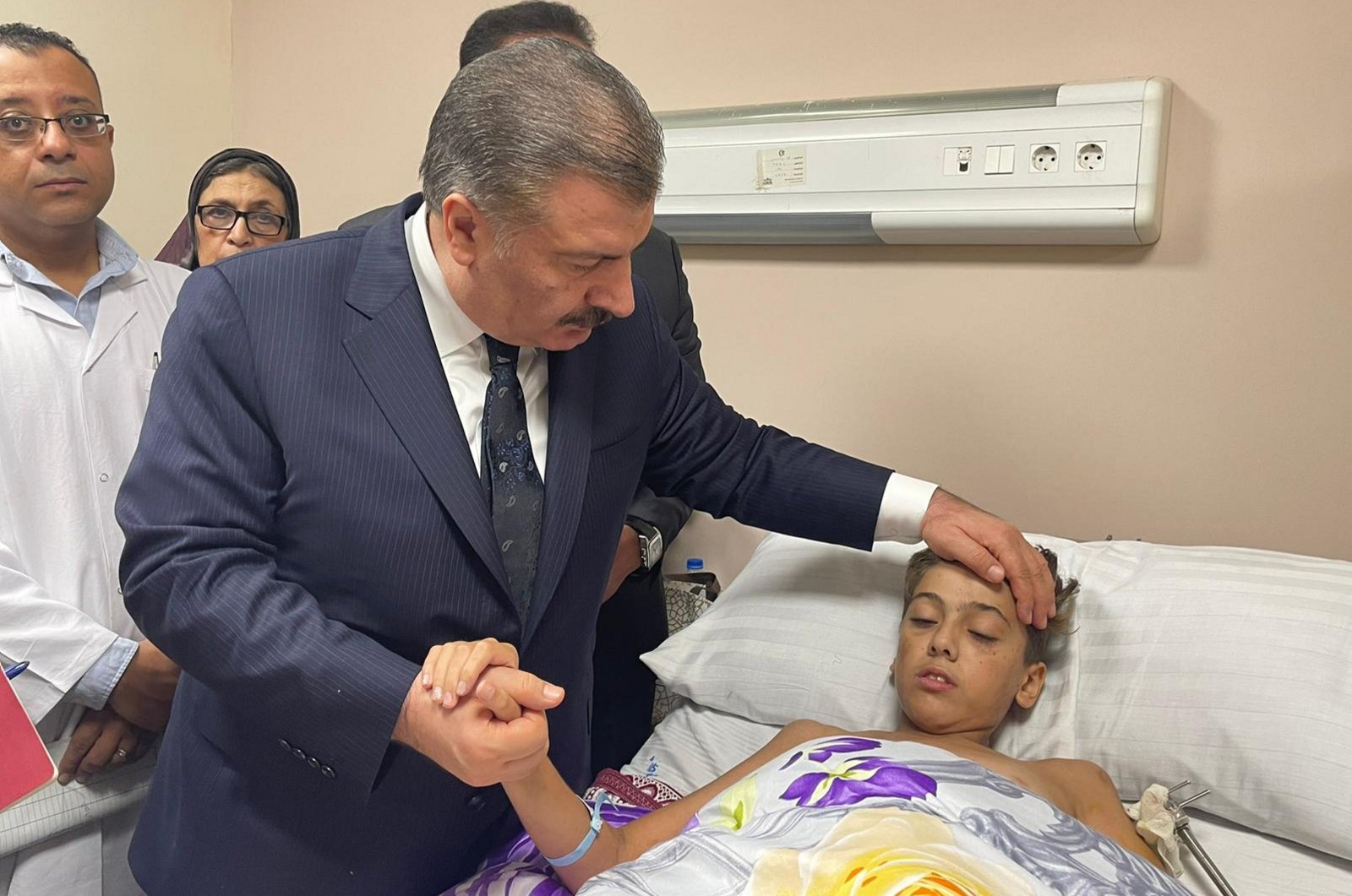 Health Minister Fahrettin Koca and his Egyptian counterpart Khaled Abdel Ghaffar (not pictured) visit injured Palestinian children at the Nasr Research Institute Hospital in Cairo, Egypt, Nov. 15, 2023. (AA Photo)