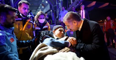 Health Minister Fahrettin Koca (R) speaks with a Palestinian cancer patient who had crossed from Gaza into Egypt after arriving at Esenboğa Airport in Ankara, Türkiye, Nov. 16, 2023. (AFP Photo)