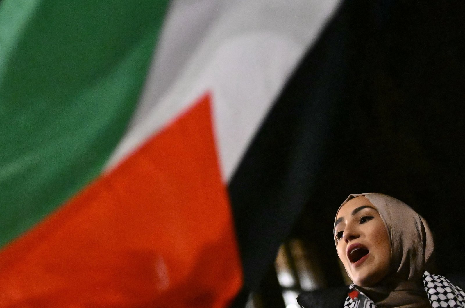 A protester chants slogans behind a Palestinian flag during a rally in support of Palestinians, outside of the Houses of Parliament, London, U.K., Nov. 15, 2023. (AFP Photo)