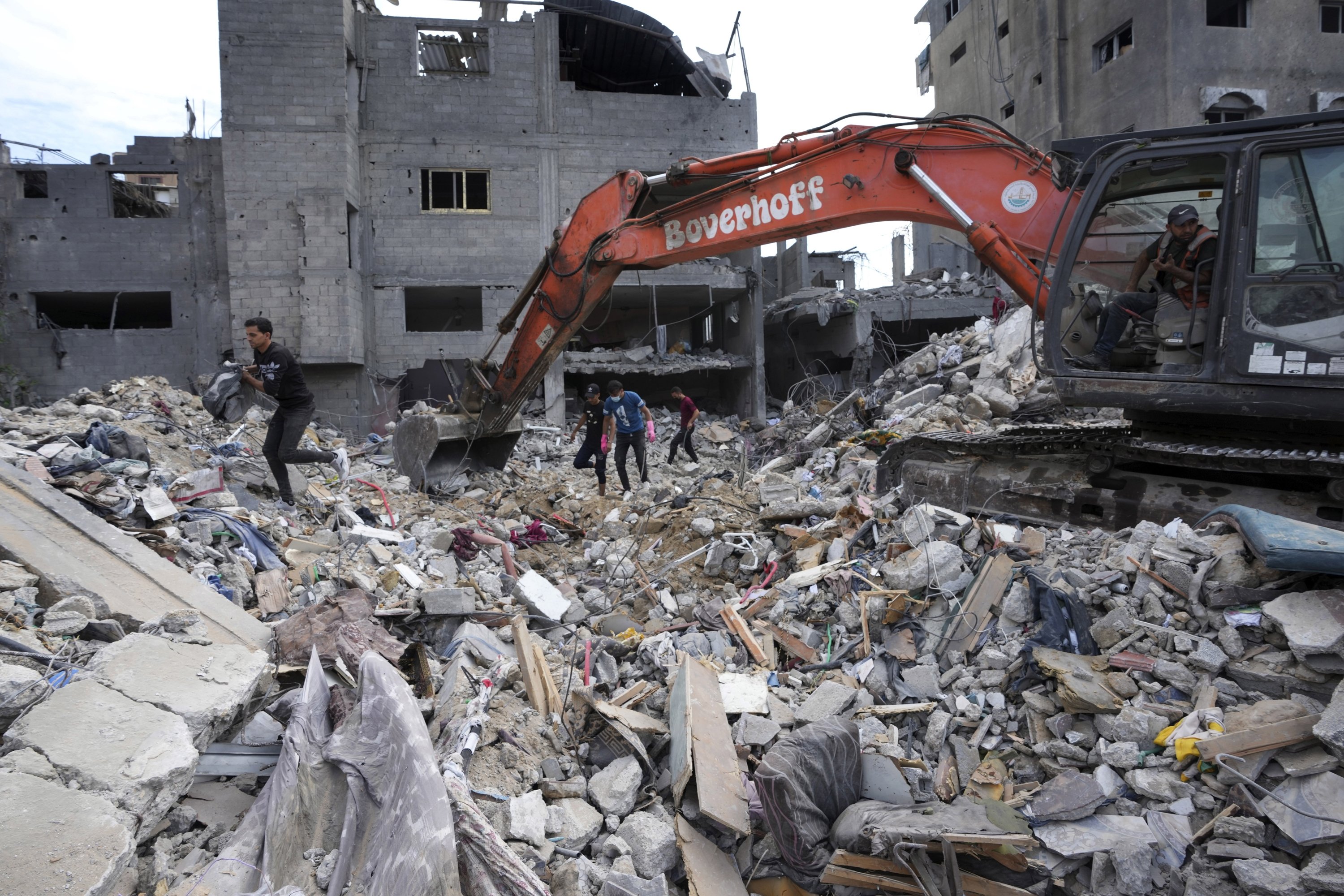 Palestinians search for the bodies of the al Meghari family killed in the Israeli bombardment of the Gaza Strip, Bureij refugee camp, Gaza Strip, Nov. 14, 2023. (AP Photo)