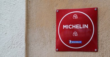 Michelin Star plate text sign with logo brand is seen on a wall. (Shutterstock Photo)