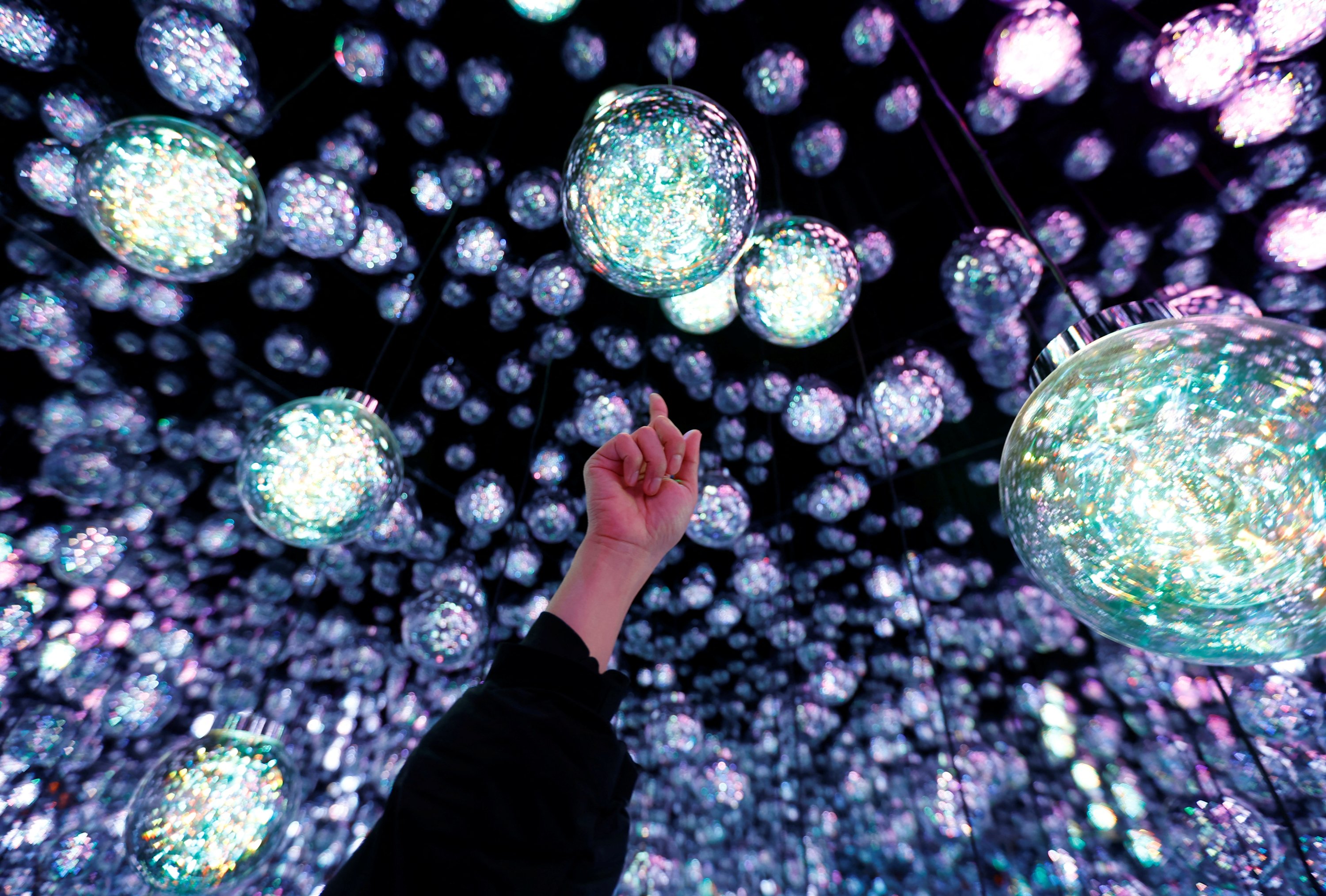 A member of the teamLab digital art group explains about an installation in preparation for the reopening of their Borderless museum in February at the Azabudai Hills complex in Tokyo, Japan, Nov. 17, 2023. (Reuters Photo)