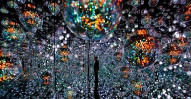 A member of the teamLab digital art group poses in an installation in preparation for the reopening of their Borderless museum in February at the Azabudai Hills complex in Tokyo, Japan, Nov. 17, 2023. (Reuters Photo)