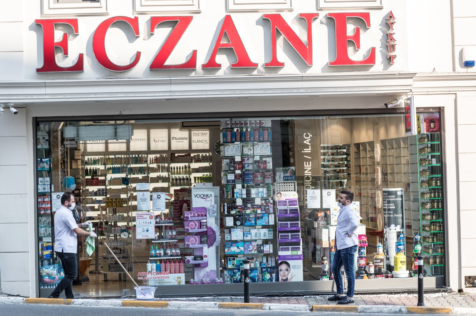 A pharmacy staff disinfects out of the pharmacy during a two-day curfew which was imposed to prevent the spread of the coronavirus disease, in Istanbul, Türkiye, April 11, 2020. (Getty Images)