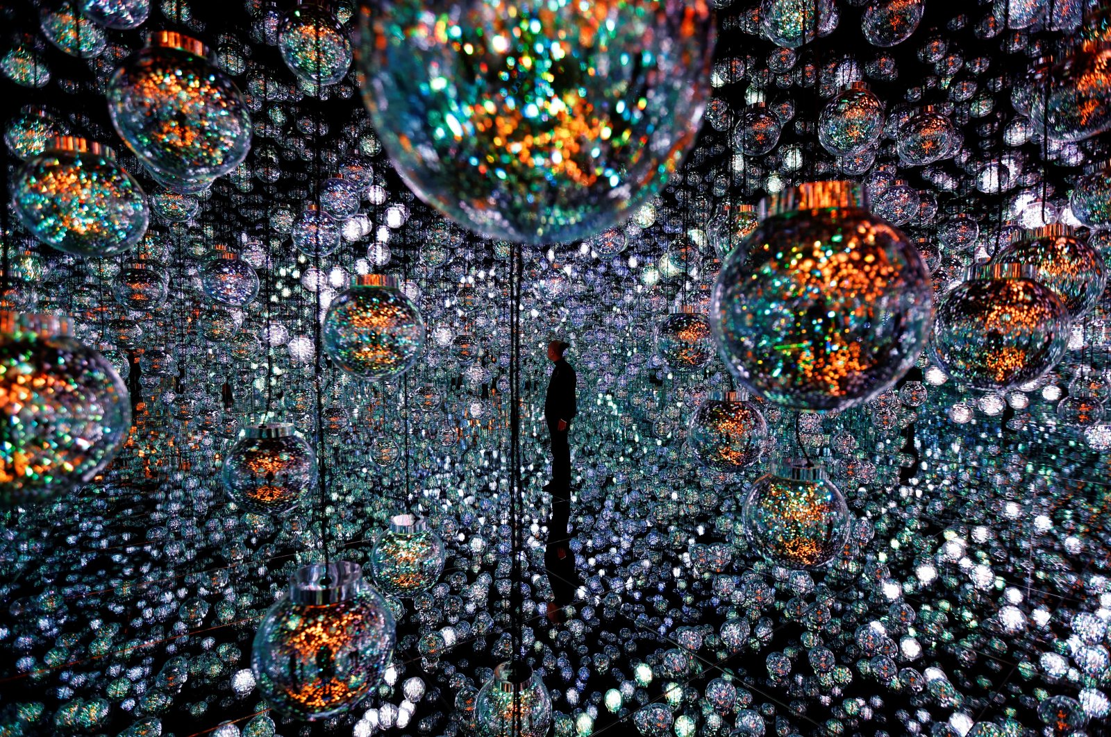 A member of the teamLab digital art group poses in an installation in preparation for the reopening of their Borderless museum in February at the Azabudai Hills complex in Tokyo, Japan, Nov. 17, 2023. (Reuters Photo)