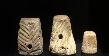 Terracotta weaving weights from the Early Bronze Age. (Photo by Peter Dore)