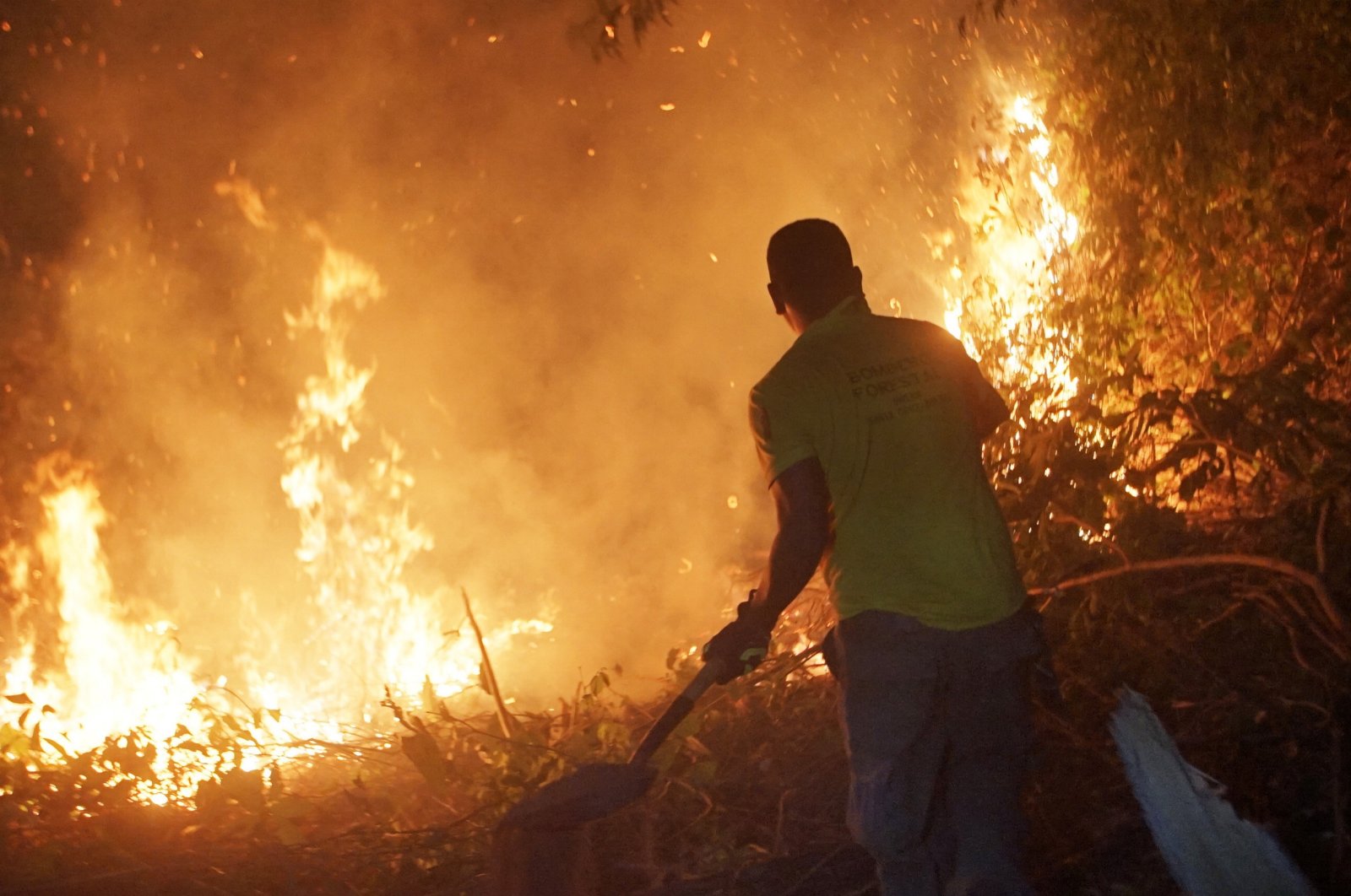 A man helps to extinguish a fire in Concepcion, Santa Cruz, Bolivia, Nov. 13, 2023. (EPA Photo)