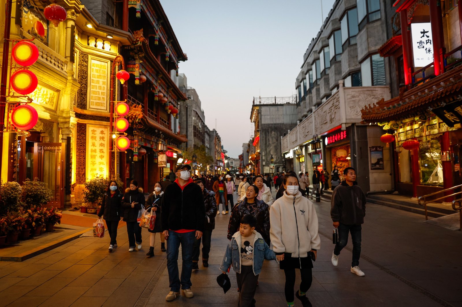 People are seen walking in a shopping district in Beijing, China, Nov. 14, 2023. Chinese health authorities warn of an increase in respiratory diseases such as mycoplasma pneumonia, COVID-19 and influenza as winter approaches. (EPA Photo)