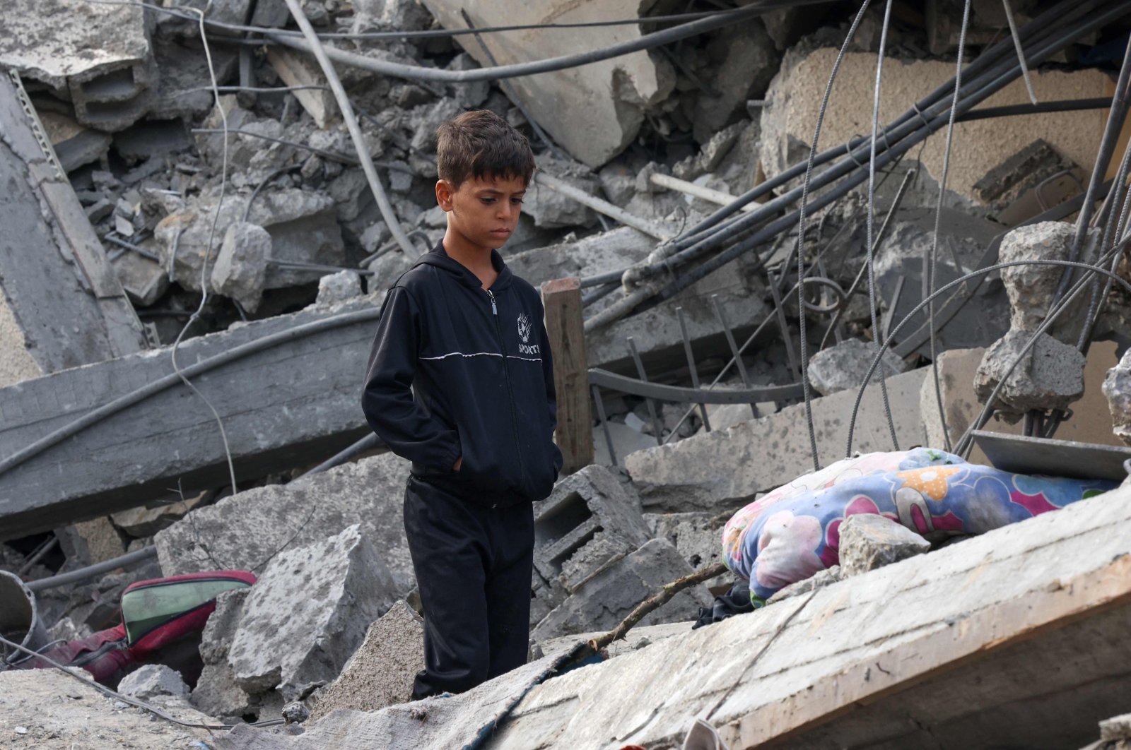 A Palestinian boy stands amidst the rubble of a building following Israeli strikes in Rafah, southern Gaza Strip, Palestine, Nov. 22, 2023. (AFP Photo)
