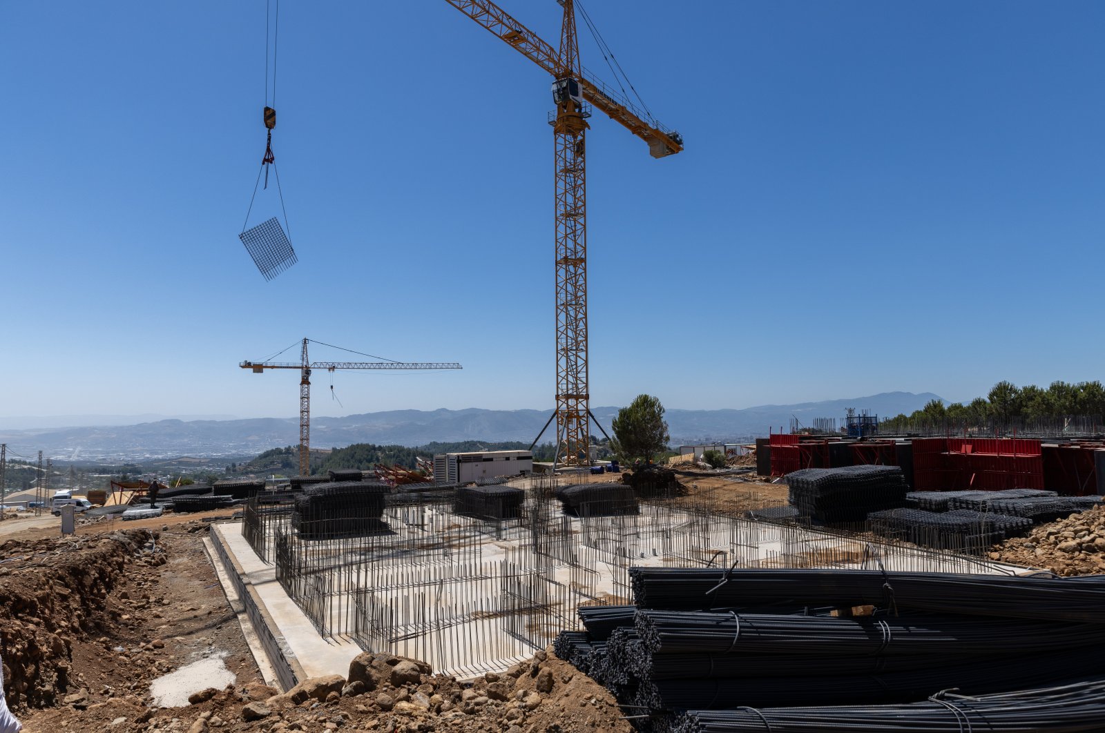 A housing estate is being built by the state-run Housing Development Administration of Türkiye (TOKI) some 15 kilometers (9.32 miles) from the center of Antakya, Hatay, southern Türkiye, July 31, 2023. (Reuters Photo)