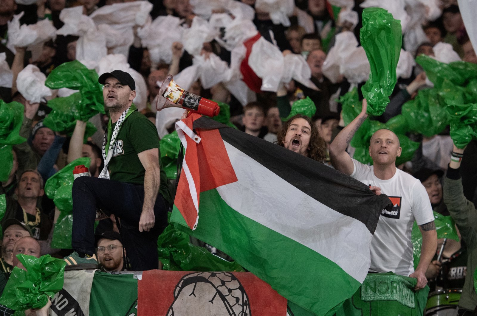 Celtic fans hold up a megaphone and the Palestine flag during the UEFA Champions League match between Celtic FC and Atletico Madrid at Celtic Park Stadium, Glasgow, Scotland, Oct. 25, 2023. (Getty Images Photo)