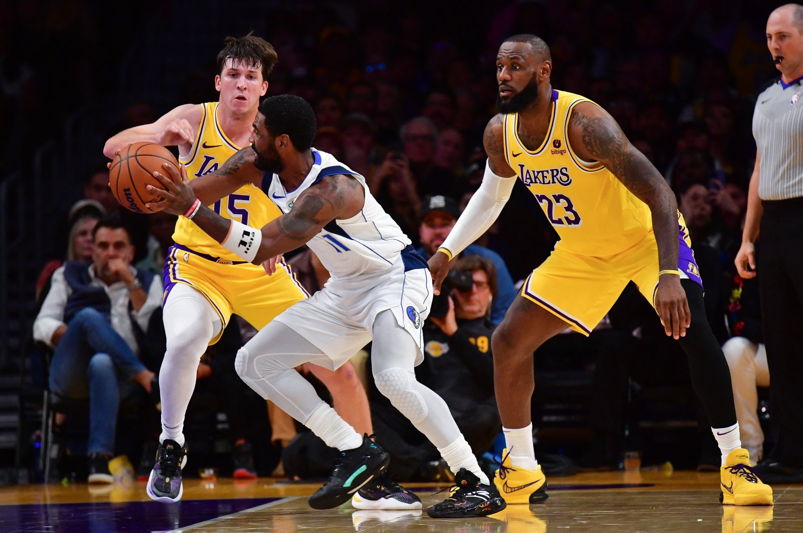 Dallas Mavericks&#039; Kyrie Irving (C) moves the ball against Los Angeles Lakers&#039; Austin Reaves (L) and LeBron James (23) during the second half at Crypto.com Arena, Los Angeles, California, U.S., Nov 22, 2023. (Reuters Photo)