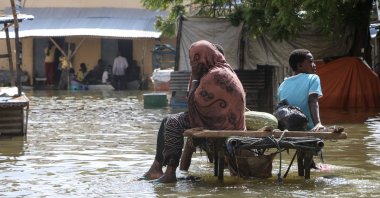 Residents sit on a cart amidst the floodwater at a submerged street in Beledweyne, Hiran region, central Somalia, Nov. 20, 2023. (EPA Photo)