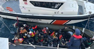 The Turkish coast guard picks up a group of 40 irregular migrants attempting to cross on a life raft over to Europe, off the coast of western Izmir province, Türkiye, Nov. 22, 2023. (AA Photo)