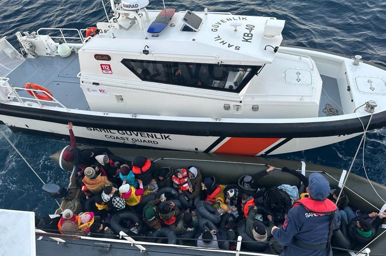 The Turkish coast guard picks up a group of 40 irregular migrants attempting to cross on a life raft over to Europe, off the coast of western Izmir province, Türkiye, Nov. 22, 2023. (AA Photo)