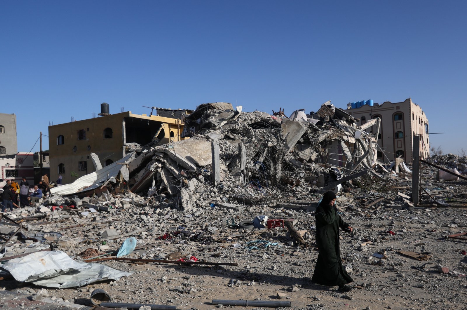 A Palestinian woman walks near a house destroyed in an Israeli strike in Khan Younis, southern Gaza Strip, Palestine, Nov. 24, 2023. (Reuters Photo)