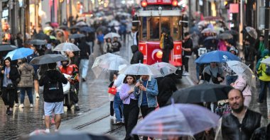 People spend time amid rainfall at Istiklal Street in Istanbul, Türkiye, Nov. 2, 2023. (AA Photo)