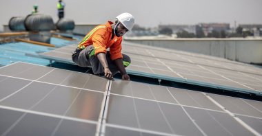 A technician from CP Solar works on the installation of solar panels at a partially solar-powered factory in the industrial area of Nairobi, Kenya, on Oct. 9, 2023. (AFP Photo)