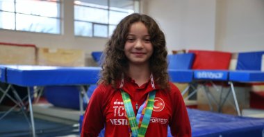 Turkish gymnast ,Tuba Bade Şahin poses for a photo with her medals, Istanbul, Türkiye, Nov. 26, 2023. (AA Photo)

