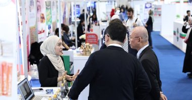 Participants are seen close to a stand of a female exhibitor at the World Halal Summit, Istanbul, Türkiye, Nov. 26, 2023. (Daily Sabah Photo)