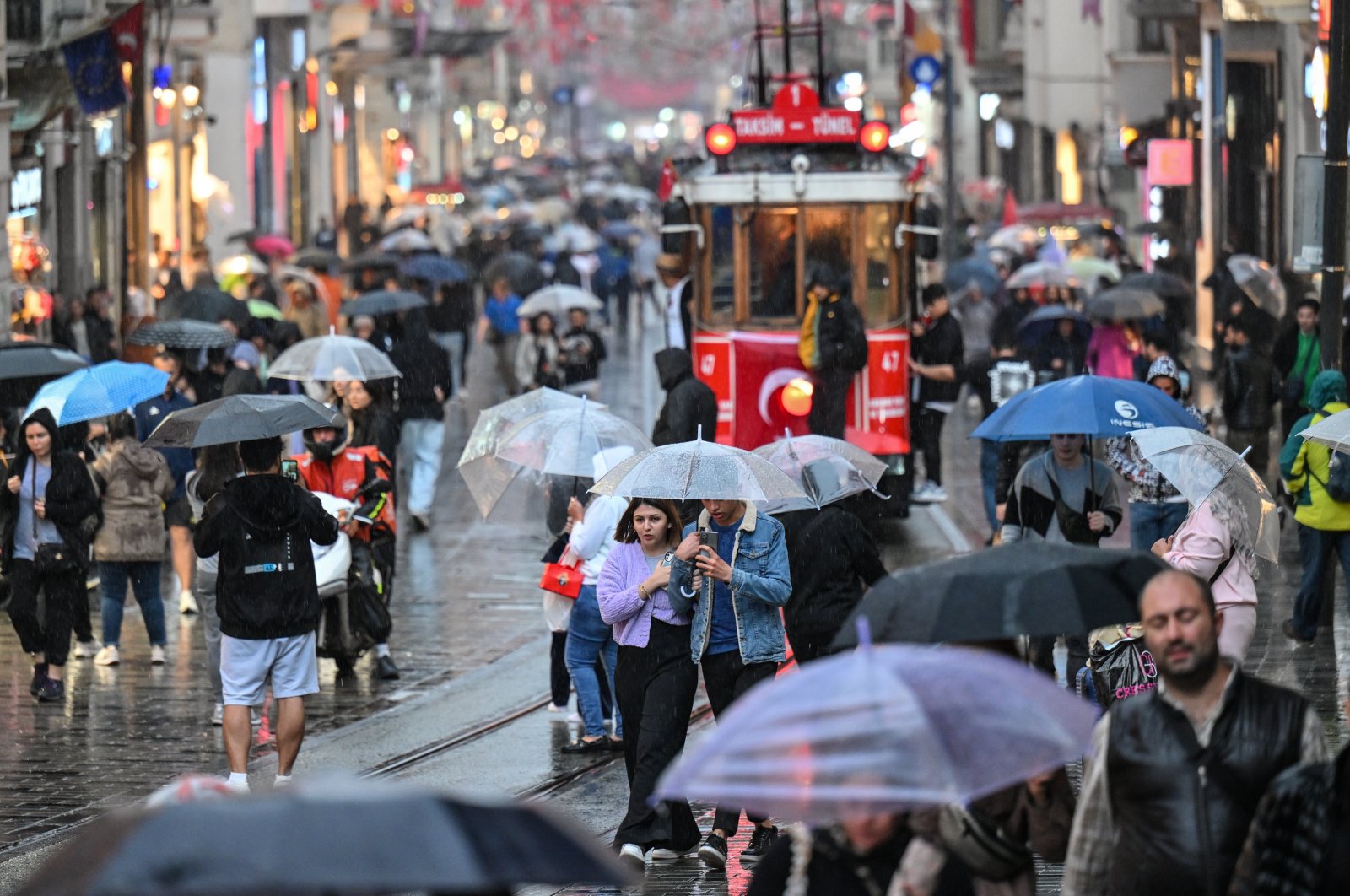 People spend time amid rainfall at Istiklal Street in Istanbul, Türkiye, Nov. 2, 2023. (AA Photo)