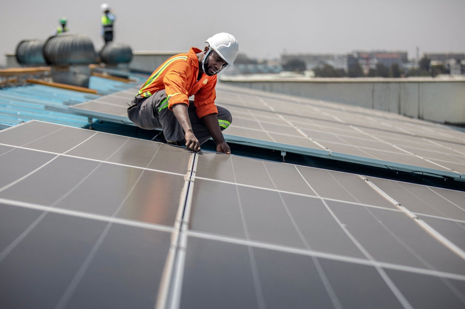 A technician from CP Solar works on the installation of solar panels at a partially solar-powered factory in the industrial area of Nairobi, Kenya, on Oct. 9, 2023. (AFP Photo)