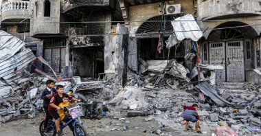 Palestinian children look at a family home destroyed by Israeli bombing, Gaza, Palestine, Nov. 6, 2023. (DPA Photo)