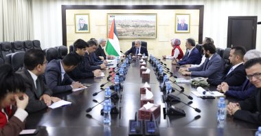 Turkish Red Crescent head Fatma Meriç Yılmaz (C-R) and the Turkish delegation officials talk to Palestinian Prime Minister Mohammad Shtayyeh (C) at a meeting, in Ramallah, Palestine, Nov. 26, 2023. (AA Photo)