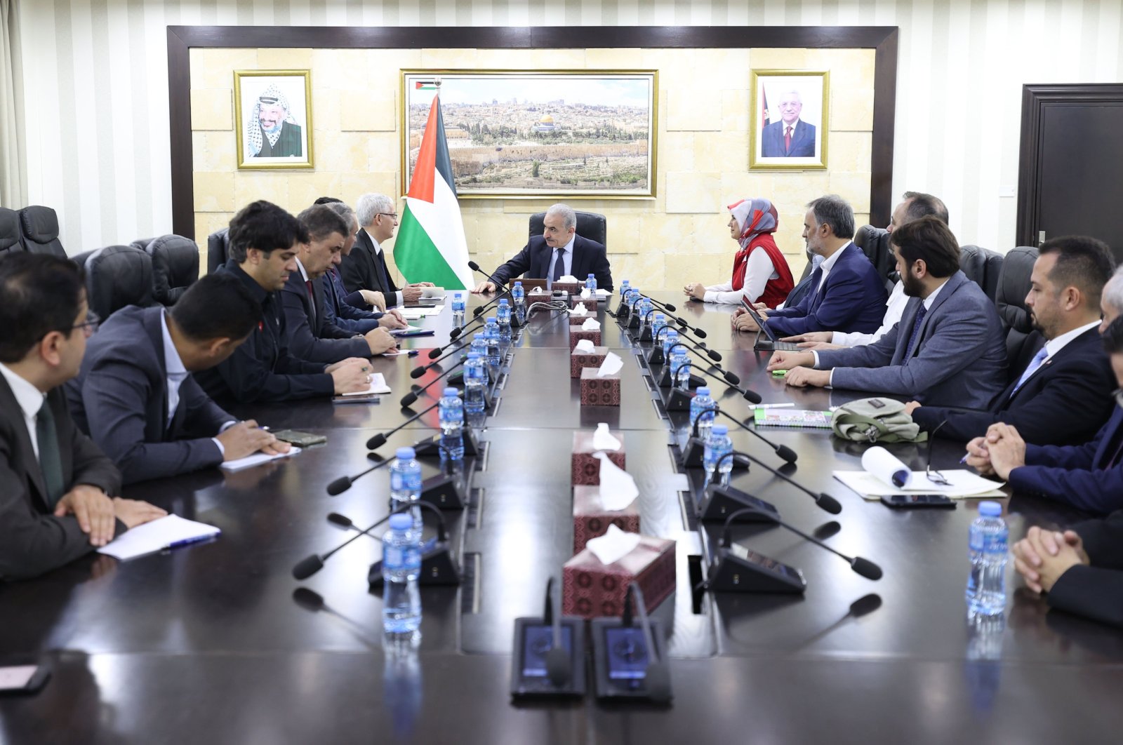 Turkish Red Crescent head Fatma Meriç Yılmaz (C-R) and the Turkish delegation officials talk to Palestinian Prime Minister Mohammad Shtayyeh (C) at a meeting, in Ramallah, Palestine, Nov. 26, 2023. (AA Photo)