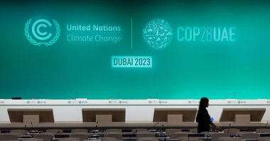 A woman walks in an empty conference room ahead of the COP28 United Nations climate summit in Dubai, UAE, Nov. 28, 2023. (AFP Photo)