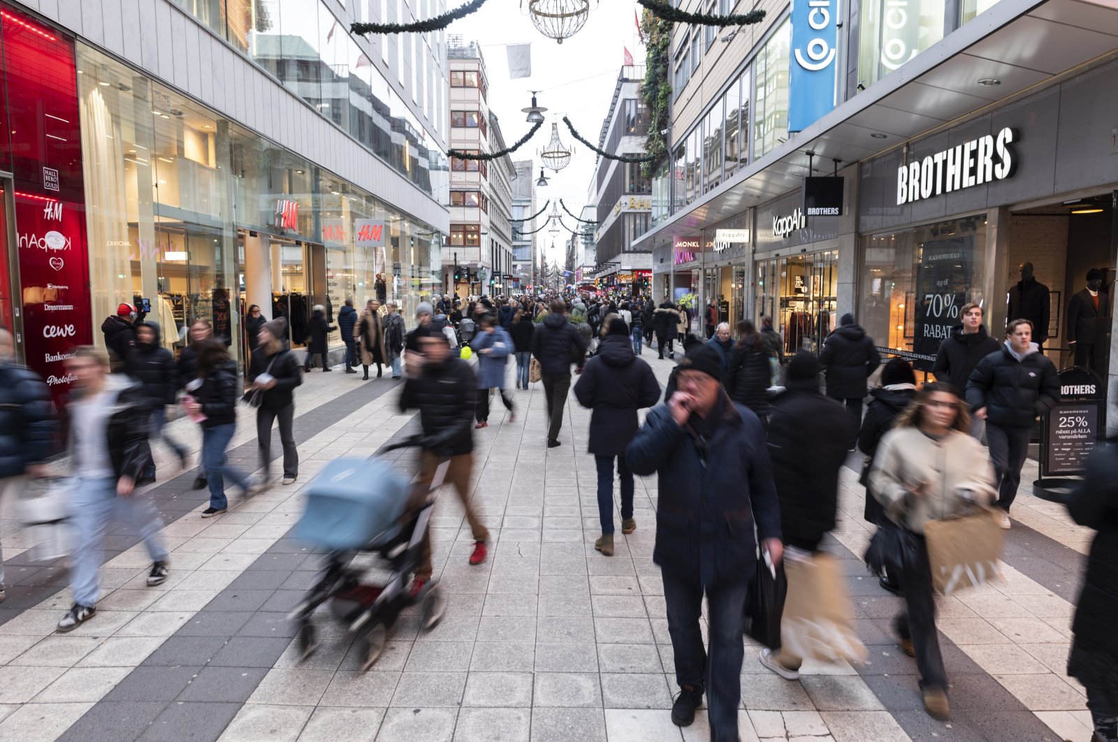 People walk on Drottninggatan in Stockholm, Sweden, Nov. 24, 2023. (AP Photo)