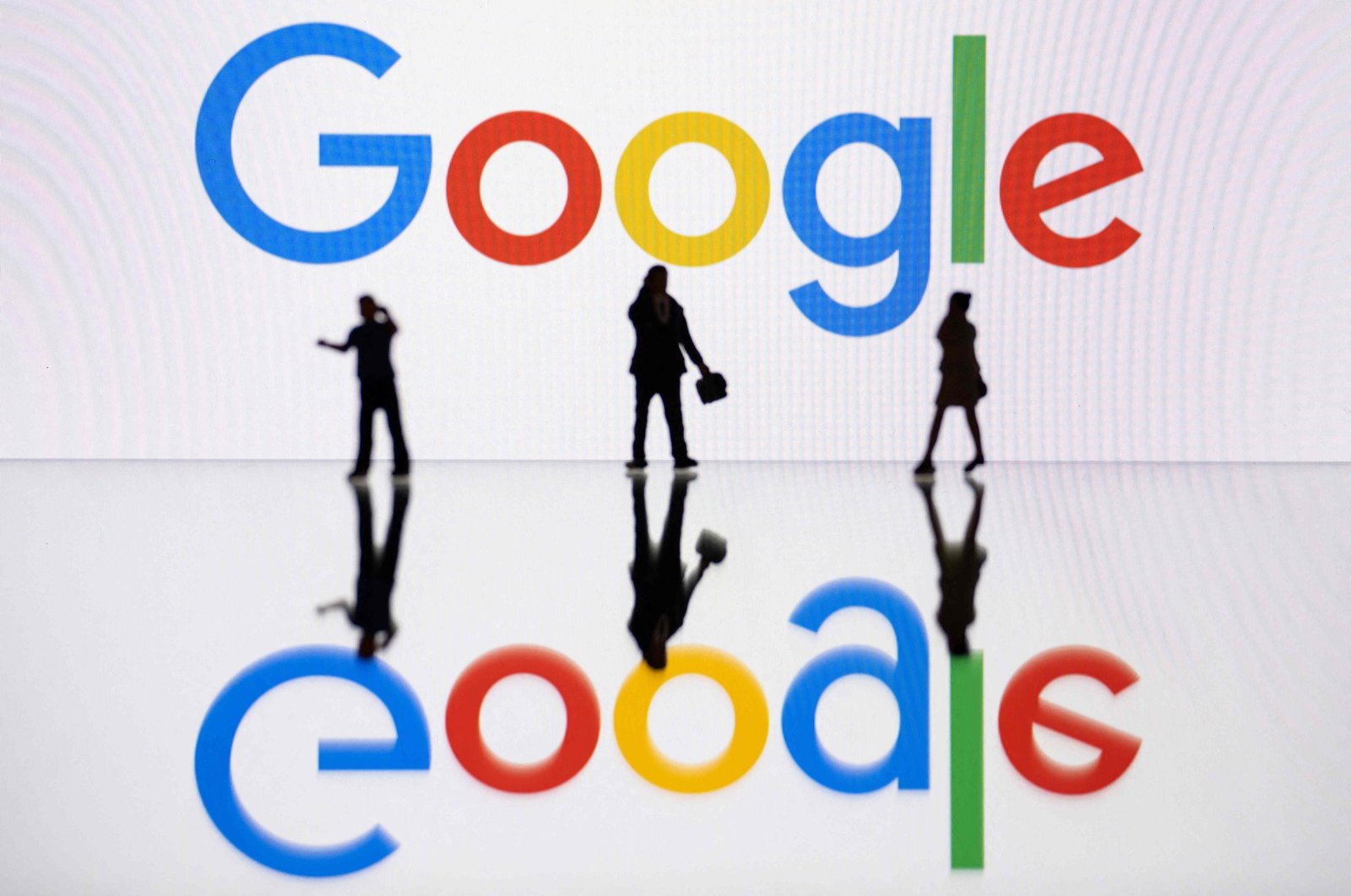 This illustration photograph taken in Mulhouse, eastern France, shows figurines next to a screen displaying a logo of Google, a U.S. multinational technology company, on Oct. 30, 2023. (AFP Photo)