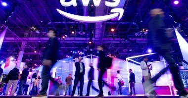 Attendees walk through an expo hall at AWS re:Invent 2023, a conference hosted by Amazon Web Services, Las Vegas, U.S., Nov. 29, 2023. (AP Photo)