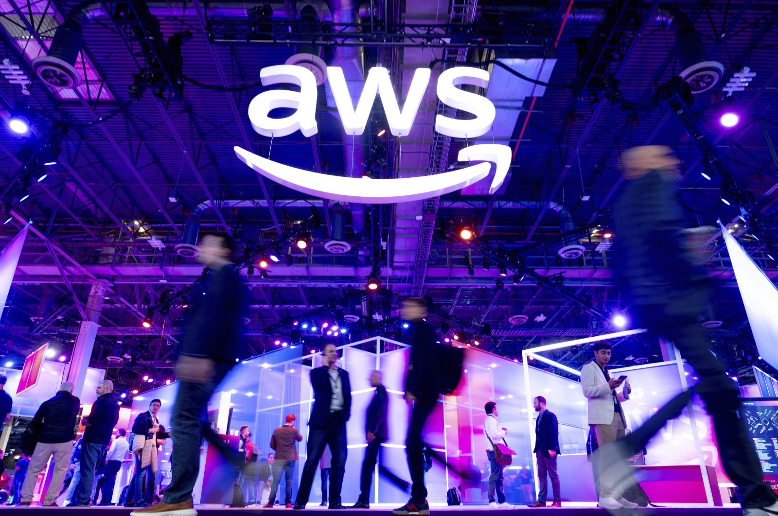 Attendees walk through an expo hall at AWS re:Invent 2023, a conference hosted by Amazon Web Services, Las Vegas, U.S., Nov. 29, 2023. (AP Photo)