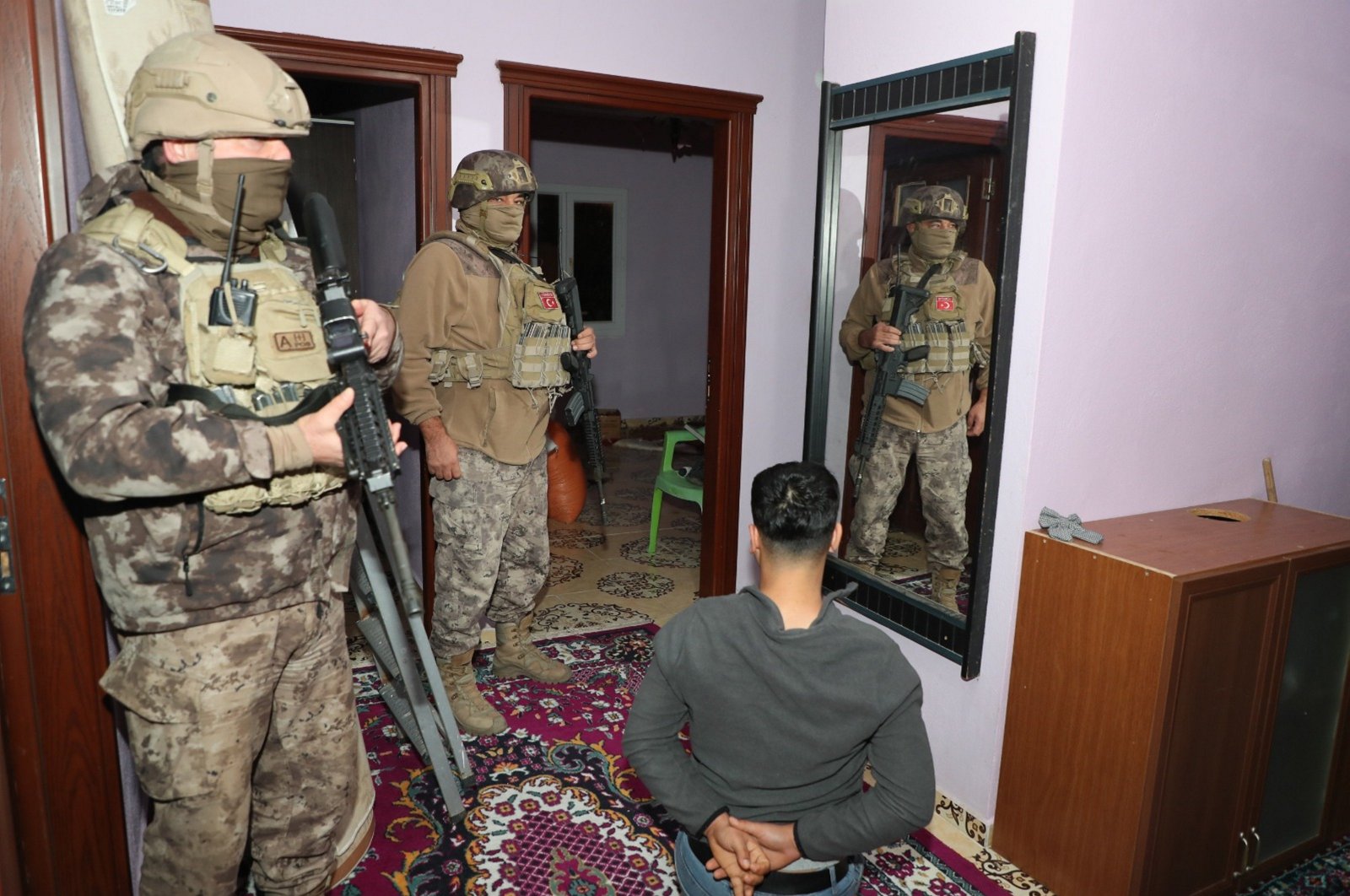 Two Turkish troopers detain a PKK suspect during a raid in southern Mersin province, Türkiye, Dec. 1, 2023. (AA Photo)