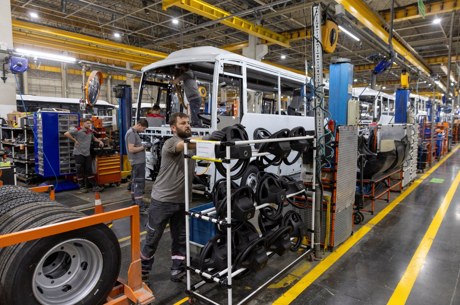 Technicians work on a bus at a production line of Türkiye&#039;s heavy commercial and armored vehicle manufacturer Otokar factory in Arifiye, a town in Sakarya province, Türkiye, July 13, 2023. (Reuters Photo)