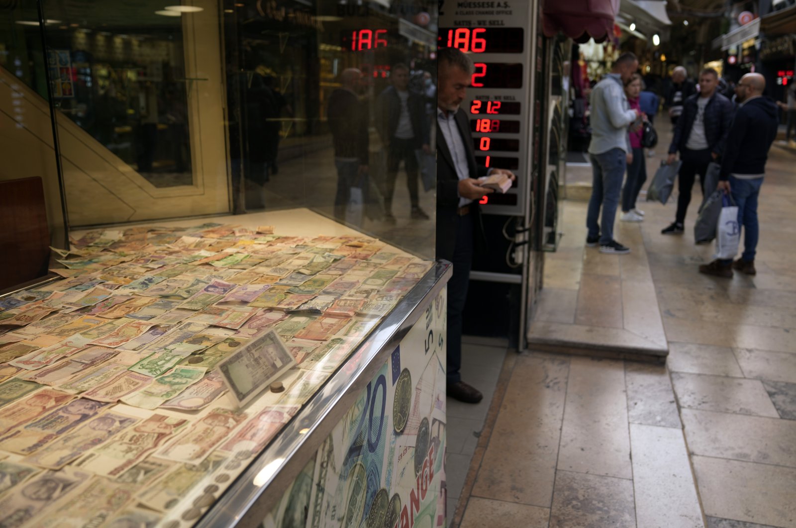 A man holds bank notes as he leaves a currency exchange shop in Istanbul, Türkiye, Oct. 14, 2022. (AP Photo)