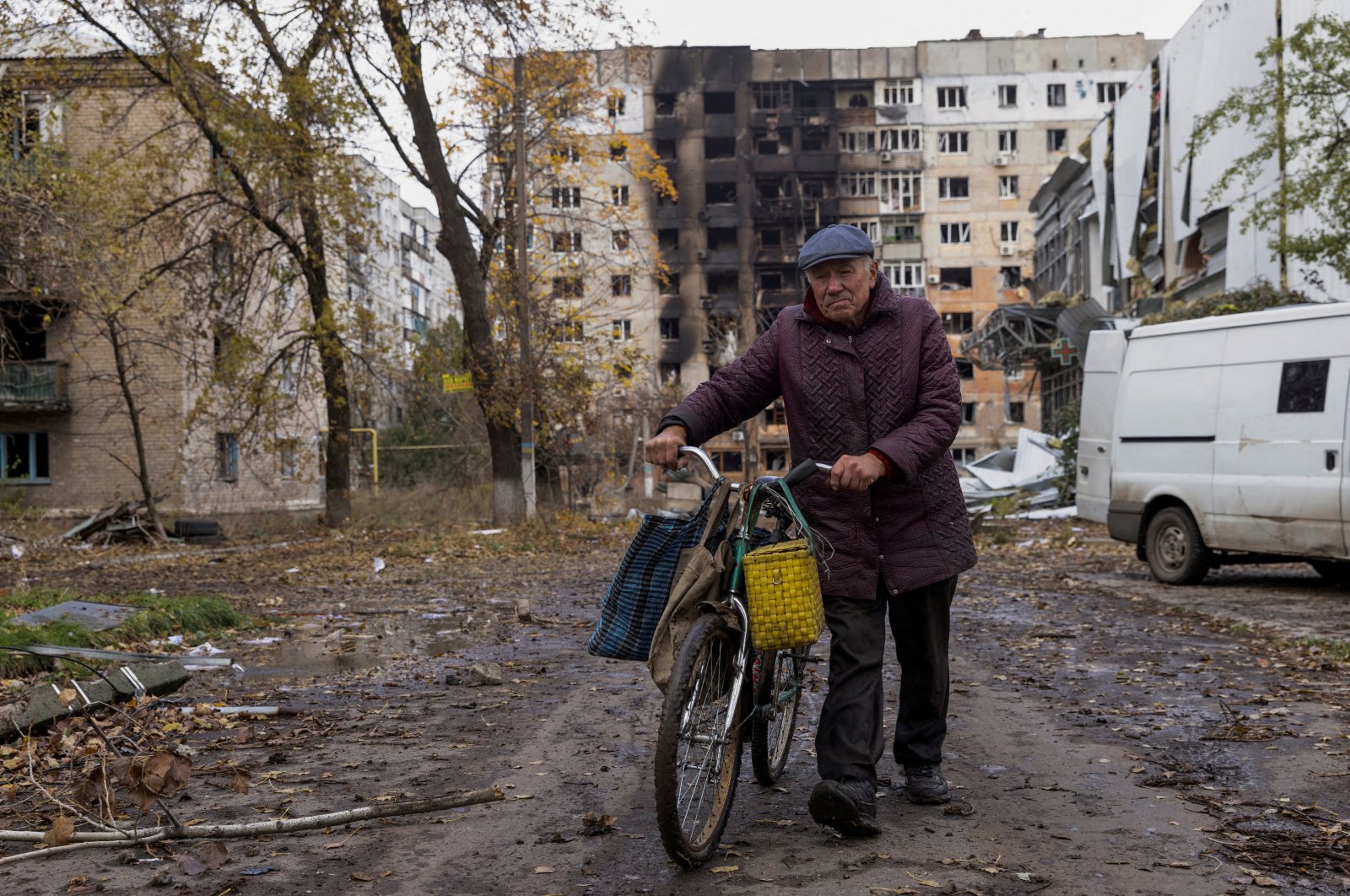 A local resident walks in front of damaged residential buildings, amid Russia's attack non Ukraine, in the town of Avdiivka, Donetsk region, Ukraine October 17, 2023. REUTERS/Yevhen Titov