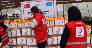 Turkish Red Crescent volunteers are photographed next to the stand with some of 2,000 packages for the flood-hit citizens of Somalia, Dec. 2, 2023. (AA Photo)
