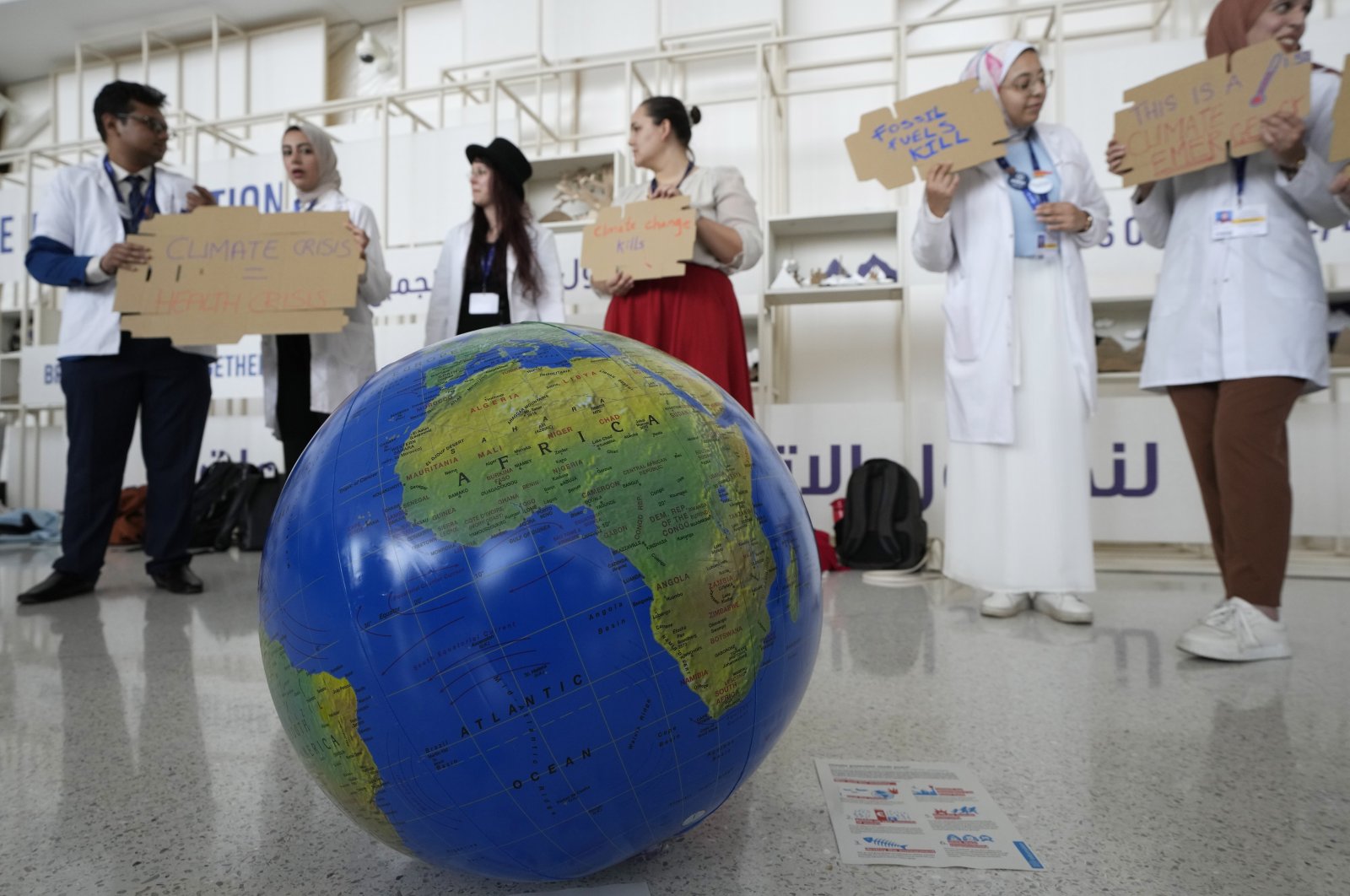 People participate in a demonstration to highlight the link between health and climate at the COP28 U.N. Climate Summit, in Dubai, United Arab Emirates, Dec. 3, 2023. (AP Photo)