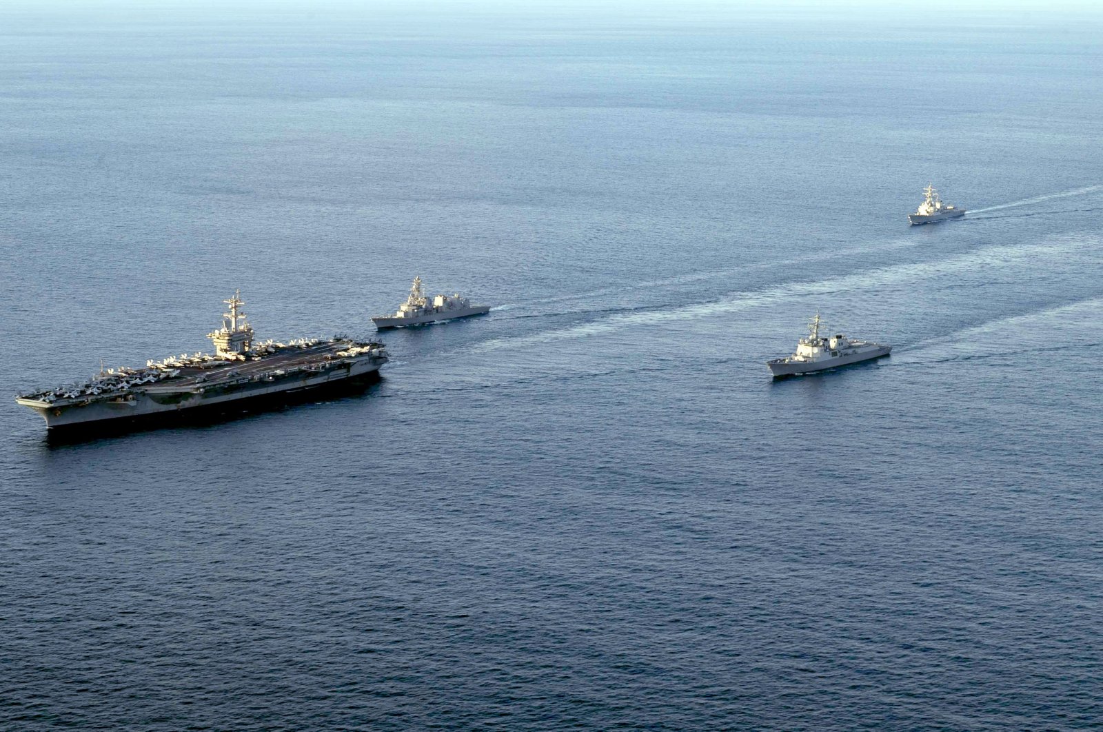 A handout photo made available by the U.S. Navy shows (L-R) the nuclear-powered aircraft carrier USS Carl Vinson, the Japan Maritime Self-Defense Force&#039;s destroyer Kirisame, South Korea&#039;s Aegis-equipped destroyer Sejong the Great, and the guided-missile destroyer USS Kidd sailing in southeastern waters off Jeju Island, South Korea, Nov. 26, 2023. (EPA Photo)