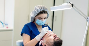A doctor performs a hair transplant surgery. (Getty Images)