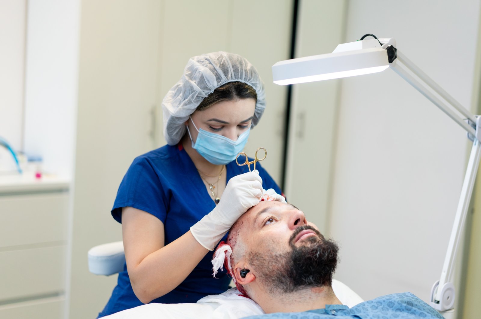 A doctor performs a hair transplant surgery. (Getty Images)