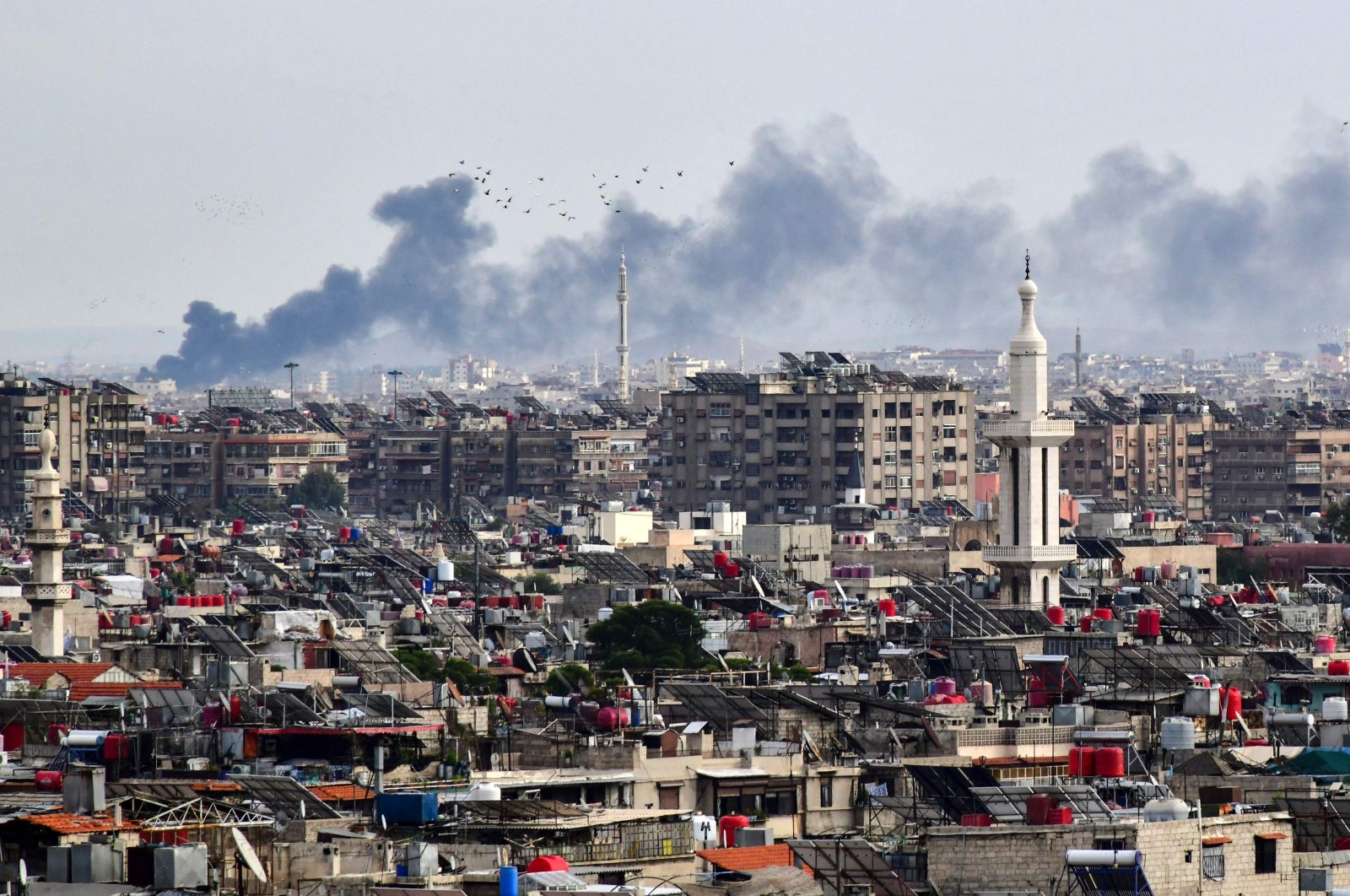 Smoke billows above buildings after an Israeli strike on the outskirts of Damascus, Syria, Nov. 22, 2023. (AFP Photo)
