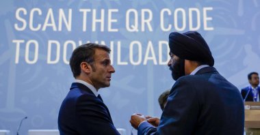 France's President Emmanuel Macron (L) listens to World Bank President Ajay Banga during the Transforming Climate Finance session at the United Nations climate summit in Dubai, United Arab Emirates, Dec. 1, 2023. (AFP Photo)
