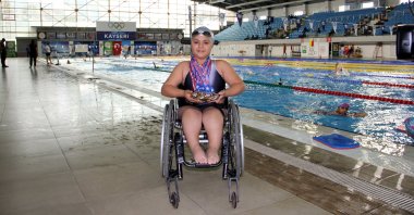 Turkish para-swimmer Ecrin Bütün poses for a photo with her medals, Kayseri, Türkiye, Nov. 29, 2023. (AA Photo)