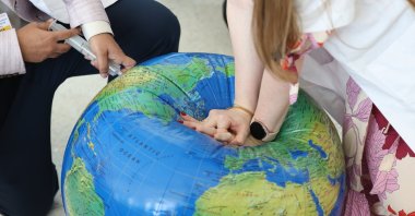 Activists perform CPR on an inflated globe model during a protest "End Fossil Fuel now! Climate Crisis = Health Crisis" during the U.N. Climate Change Conference (COP28), Dubai, UAE, Dec. 6, 2023. (EPA Photo)